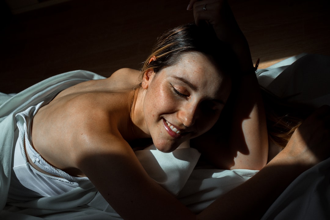 topless woman lying on bed