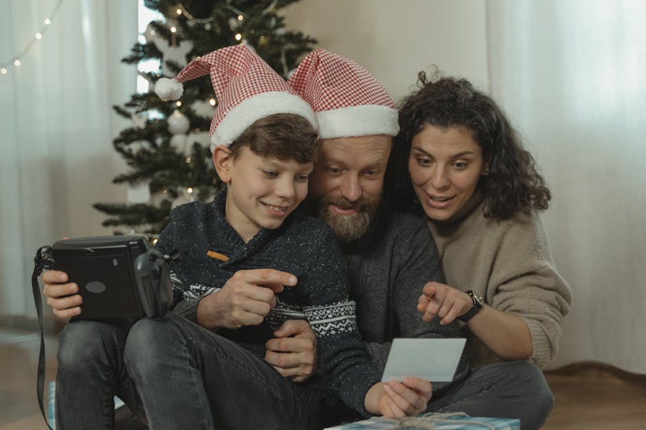 A happy family capturing holiday memories with instant photos by the Christmas tree.