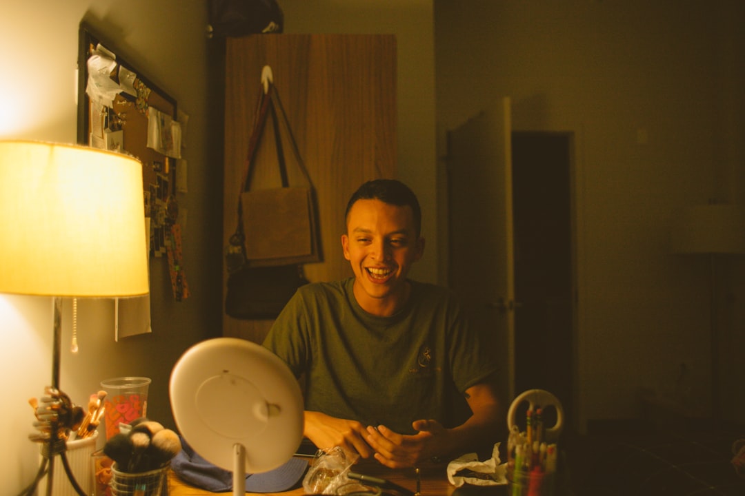 man in black crew neck shirt sitting on chair
