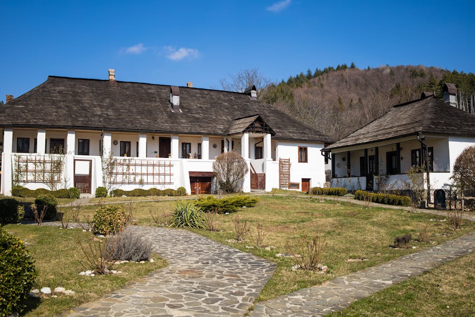 Picturesque rural scene of vintage houses with a stone pathway in a serene countryside setting.