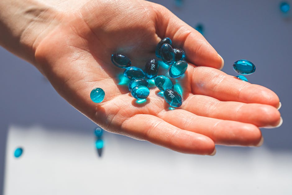 Close-up of blue oval pills in hand, highlighting healthcare and medication themes.