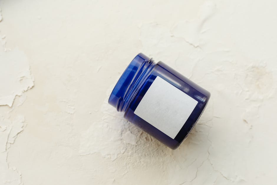 Simple blue container with label on a textured white background, perfect for mock-ups or product presentations.