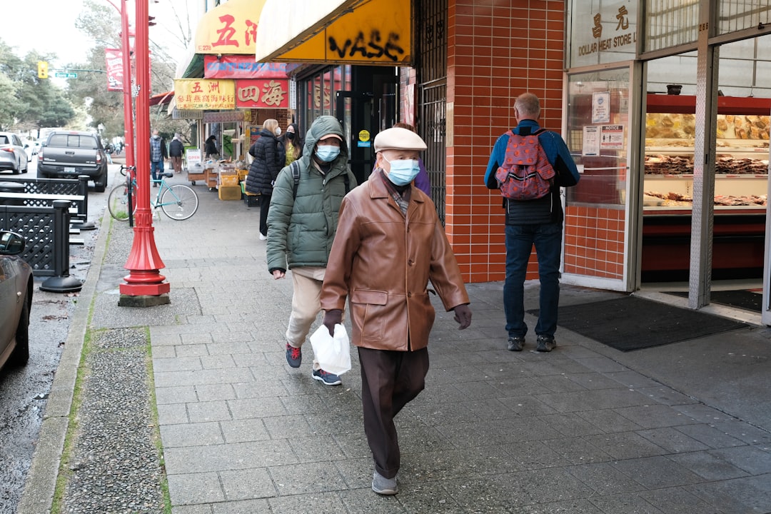 a group of people walking down a sidewalk