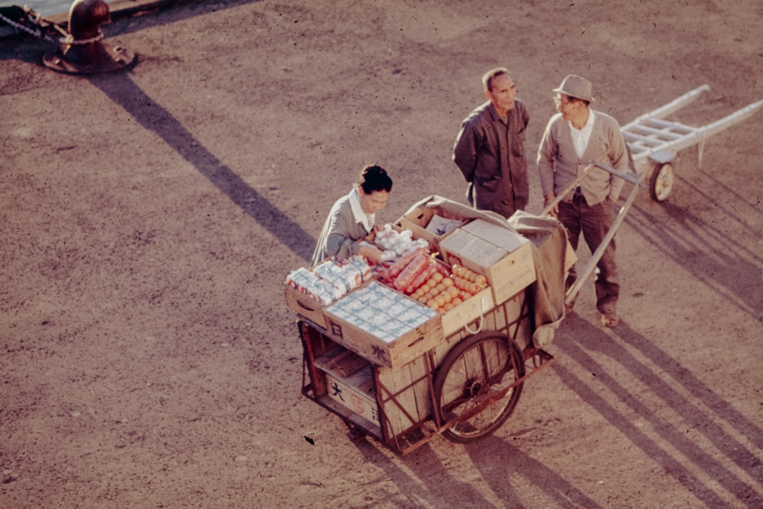 A group of men standing around a cart