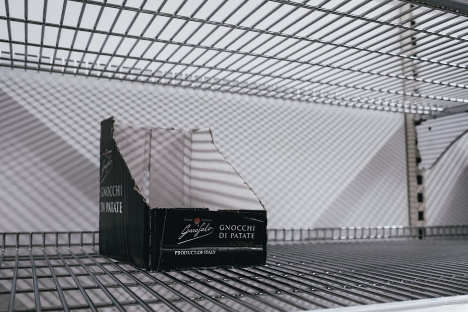 An empty supermarket shelf with an Italian gnocchi box symbolizing scarcity.