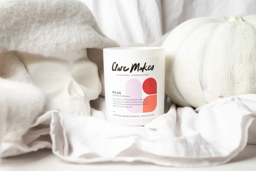 a white coffee mug sitting on top of a white blanket