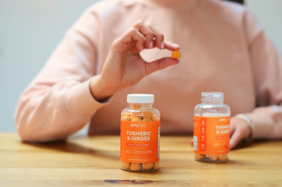 Close-up of turmeric and ginger gummies being held. Perfect for health and wellness content.