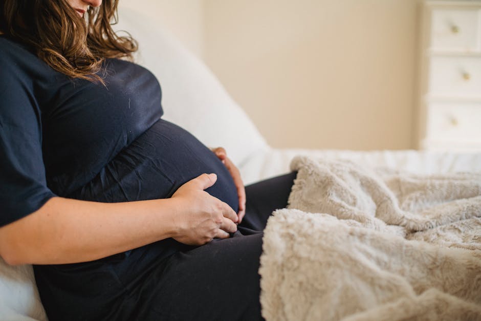Peaceful pregnant woman in a cozy bedroom setting, enjoying a quiet moment.