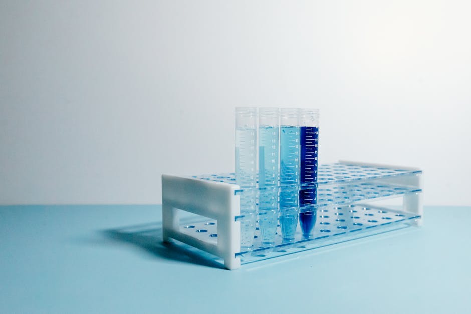 A minimalist arrangement of test tubes on a blue surface, perfect for science and laboratory themes.