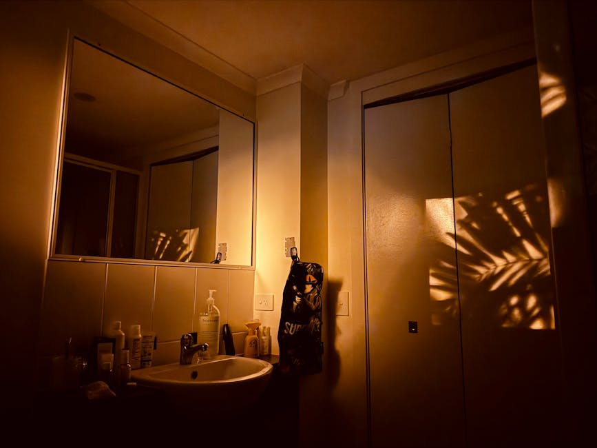 Warm atmospheric bathroom in Cairns, showcasing shadowed palms and serene lighting.