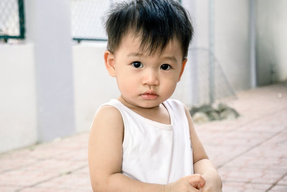 Cute portrait of a young child standing outdoors, capturing innocence and curiosity.
