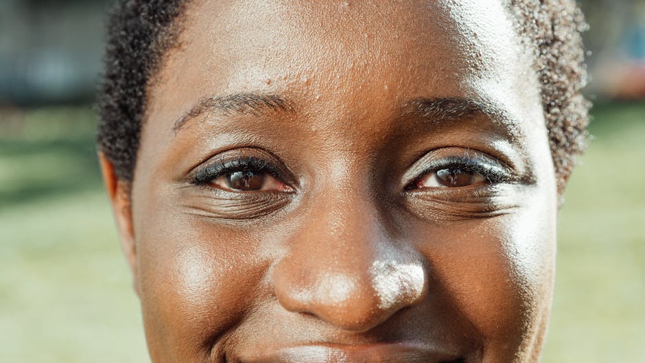 A close-up portrait highlighting joyful facial features outdoors.